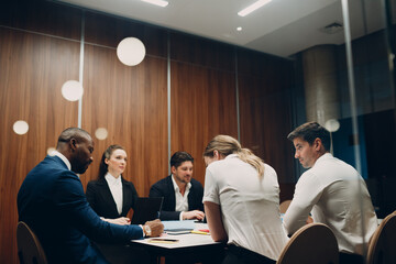 Businessman and businesswoman team at office meeting. Business people group conference discussion sit at table with boss man and woman