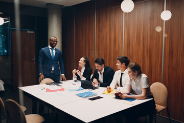 Businessman and businesswoman team at office meeting. Business people group conference discussion sit at table with boss man and woman