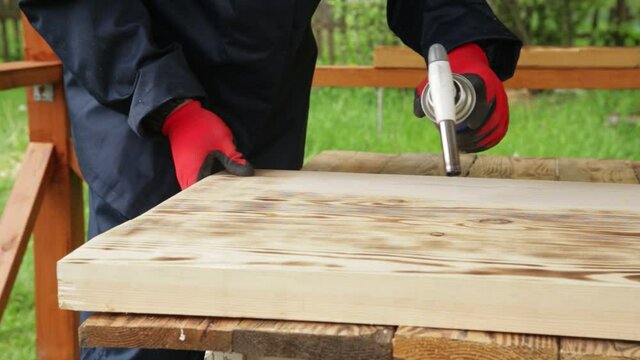 Firing wood with a gas burner for finishing. Firing technology, close-up, industrial