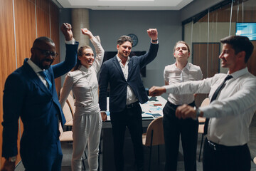 Businessman and businesswoman team doing warming up exercises before office meeting. Business healthy successful people group man and woman after conference discussion with boss.