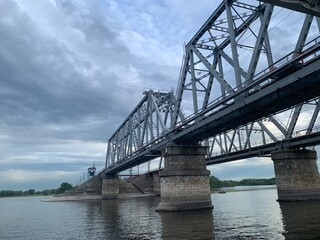 The gray Samara railway bridge over the surface of the Samara river; photo from the river