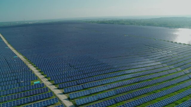Aerial view of hundreds of solar panels on wild field