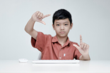 Photo of the adorable young happy boy looking at the camera, on the white background.