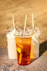 Summer drinks in plastic glasses with a lid and straws. Take away. Concept. Poster. Photo