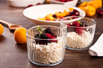 cottage cheese and yougurt with granola, berries and fruits apricot for healthy breakfast.