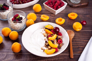 cottage cheese and yougurt with granola, berries and fruits apricot for healthy breakfast.