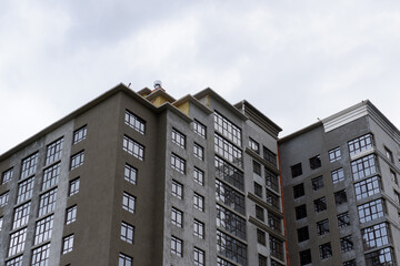 The upper floors of a multi-storey building against a gray sky