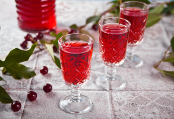 glasses of cherry brandy liqueur with ripe berries
