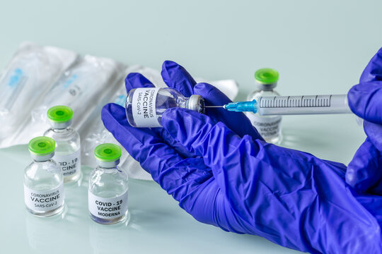 Minsk, Belarus, 03.21.2021. Bottle with vaccine against COVID-19 in scientis's hand in research laboratory. Vaccination development concept.