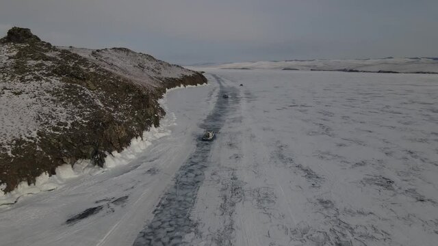khivus on a hovercraft rides on the frozen lake Baikal, a trip to Russia. High quality 4k footage