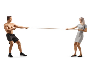 Full length profile shot of a fit sporty man and a young woman pulling a rope