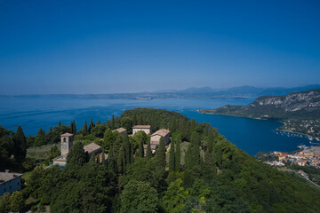 Fototapeta na wymiar Monastery on the Eremo di San Giorgio hill,.Lake Garda, Italy. Home of Italian monks, lake garda. Aerial view of Eremo di San Giorgio, Bardolino. Aerial panorama Monastery on the hill.