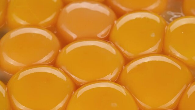 eggs yolks close up, rotation. yolks for making dough. Yolk for cooking. 4K UHD video 