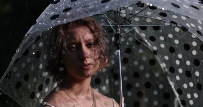 Teenage Beautiful Girl With An Umbrella In The Pouring Rain And Sunshine. Vacation Concepts. Slow Motion. Cinematic Look