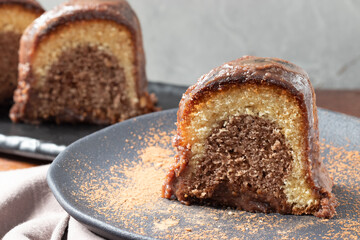 Delicious chocolate cake on black plate.