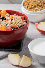 Fruits salad with granola, quinoa and yogurt. Healthy food concept. Selective focus.