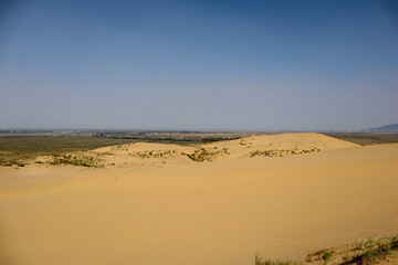 scenic view to sand dune Sarykum in Dagestan and Caspian sea