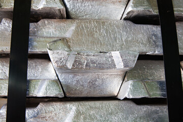 Stack of raw aluminum ingots (bars) in aluminum wire plant. Close up view.