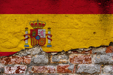 Graphic Concept with a Flag of Spain painted on a damaged brick wall.