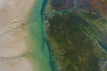 aerial view of sea, sand emerald water and a kayak