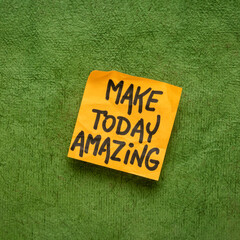 Make today amazing reminder - handwriting on a sticky note against green textured paper,...