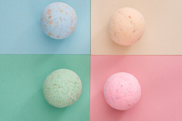 bath bombs pink, cream, blue and green on coloured background