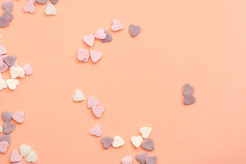 sprinkling for sweets in the shape of hearts in white, purple and pink colours