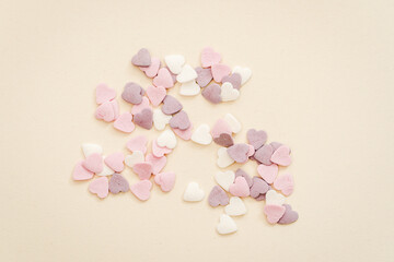 Fototapeta na wymiar sprinkling for sweets in the shape of hearts in white, purple and pink colours
