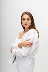 young attractive caucasian woman with long brown hair in shirt, blue jeans on white studio background. skinny pretty lady posing at bright room. portrait of beautiful female
