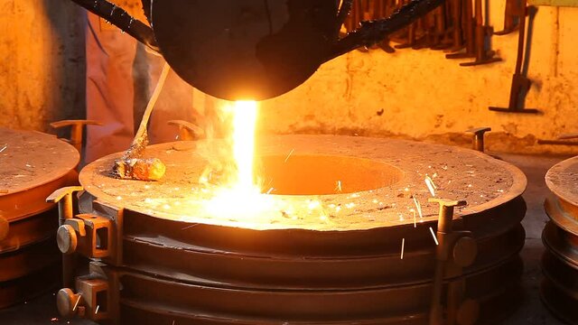 Trabalho &aacute;rduo em uma fundi&ccedil;&atilde;o. Forno de fus&atilde;o de metal em usina sider&uacute;rgica. Vazamento de metal fundido, metalurgia, fundi&ccedil;&atilde;o de a&ccedil;o. Fabrica&ccedil;&atilde;o de a&ccedil;o