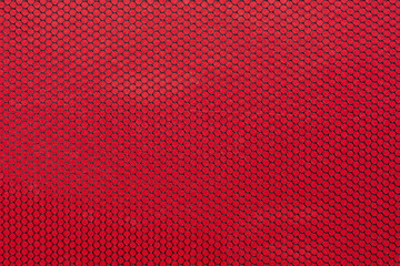 Black mesh texture isolated on red background