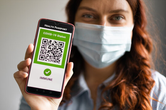 Young Girl Wearing Face Mask Holding A Passport, Ticket Pass And Smartphone With Digital Health Passport App For Travel During Covid-19 Pandemic.