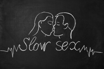 Drawing on a chalk board a man kisses a woman. Slow sex concept