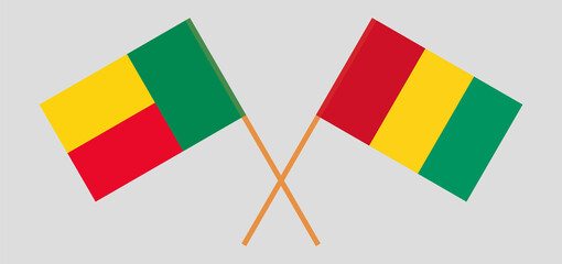 Crossed flags of Benin and Guinea. Official colors. Correct proportion