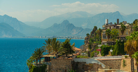 Naklejka premium ANTALYA, TURKEY: Top view of the old town, the sea and the mountains on a sunny summer day in Antalya.