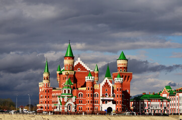 The building of the theater of dolls made of red and white brick in the form of a castle. Russia Yoshkar Ola 01.05.2021. High quality photo