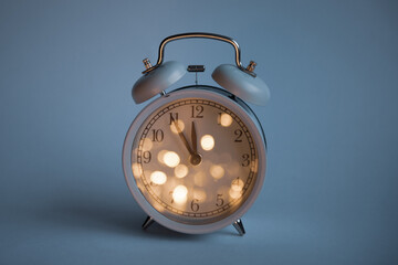 large clock showing 12 o'clock on a uniform blue background with place for text christmas theme. High quality photo