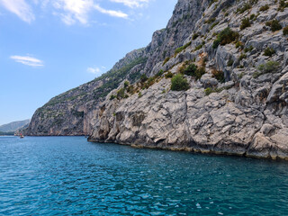 Fototapeta premium Hidden coves near the ancient city of Olympos. Boat tour. Calm and quiet coves visited by boat tour. Coves where Caretta Carettas spawn.