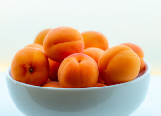 Apricots fresh, juicy, delicious summer snack in a white bowl