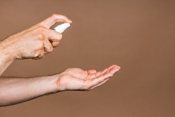 Hand wash. Man hands using wash hand sanitizer gel pump dispenser for protection coronavirus and bacteria, health care concept. Close-up.