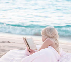 Relax concept. Cozy and comfortable bed near the sea. Summer vacations still life. Woman reading a book. - 448156276