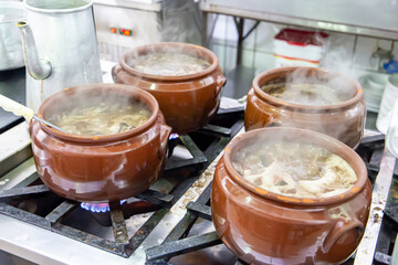 Ceramic pot with feijoada, typical Brazilian food. In a restaurant in Brazil