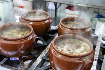 Ceramic pot with feijoada, typical Brazilian food. In a restaurant in Brazil
