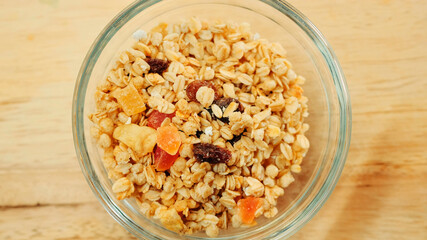 Pouring muesli breakfast mix in bowl. Close up shot