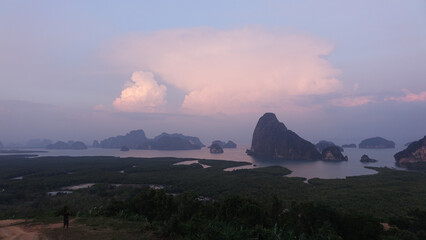 Lush rainforest mountain landscapes with hazy sky at a campsite in Phang Nga, Thailand.