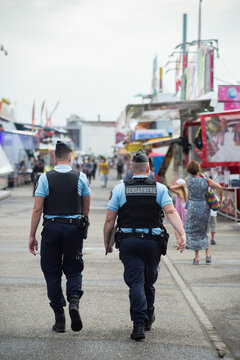 Mulhouse - France - 30 July 2021 - Portrait on back view of french national gendarmes patrolling at the fun fair during the covid-19 pandemic