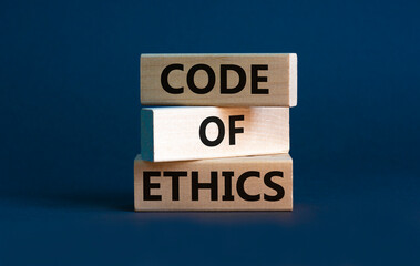 Code of ethics symbol. Concept words 'Code of ethics' on wooden blocks on a beautiful grey background. Business and code of ethics concept. Copy space.
