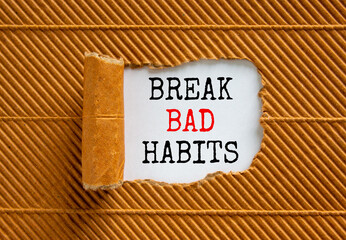 Break bad habits symbol. Words 'Break bad habits' appearing behind torn brown paper. Beautiful brown background. Business, psychology and break bad habits concept, copy space.