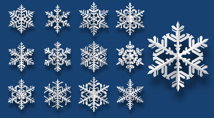 Set of beautiful complex paper Christmas snowflakes with soft shadows, white on blue background