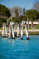 Obraz premium Wooden bricole ,wooden mooring poles in the water, Venice, Italy,2019